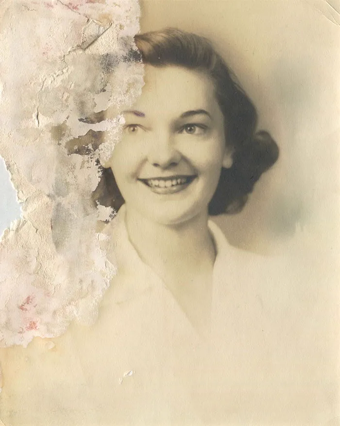 Water-damaged vintage portrait before restoration